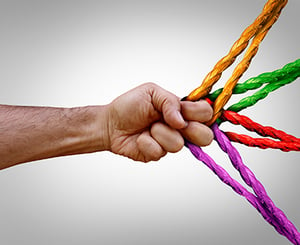 fingers pulling on four colored ropes
