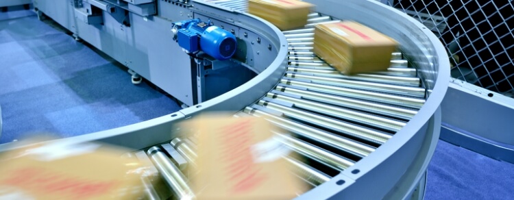 shipping boxes traveling quickly on rollers in a factory environment