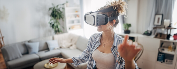 woman wearing and interacting with virtual reality headset