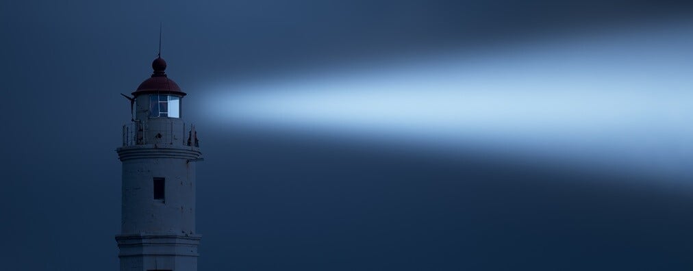 lighthouse shining at night