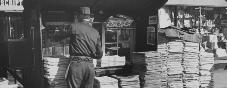 historical black and white image of a newsstand