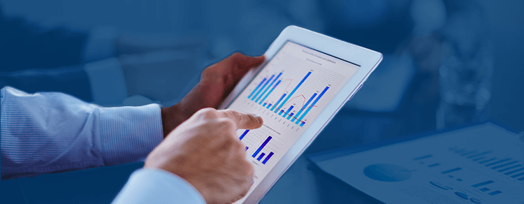 light-skinned hand pointing at bar chart on tablet screen