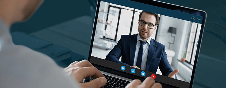 video conference with brunette man wearing suit and glasses