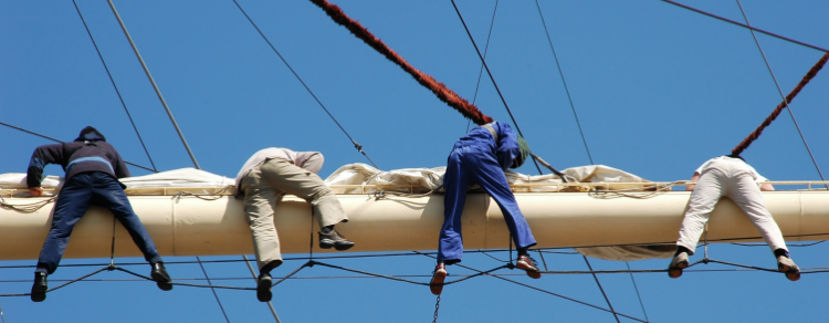 ship crew working on sail