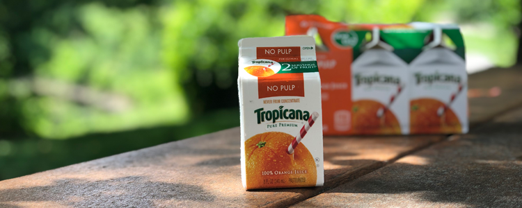 Tropicana Orange Juice on a picnic table in a park